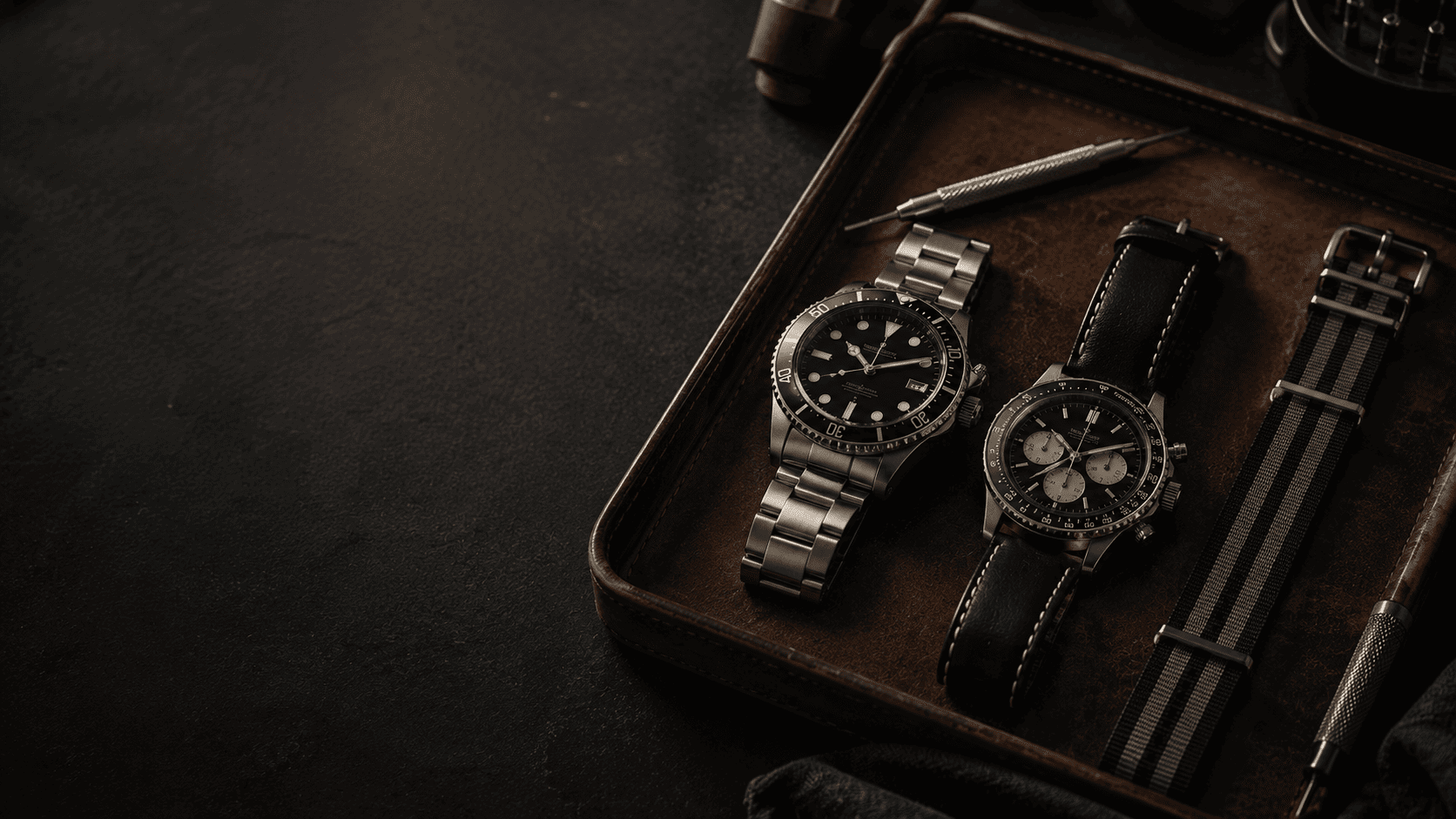 Mid-tier watches and tools arranged on a leather tray